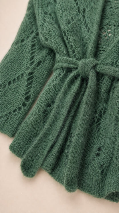 Close-up detail of green knit cardigan texture and tie belt