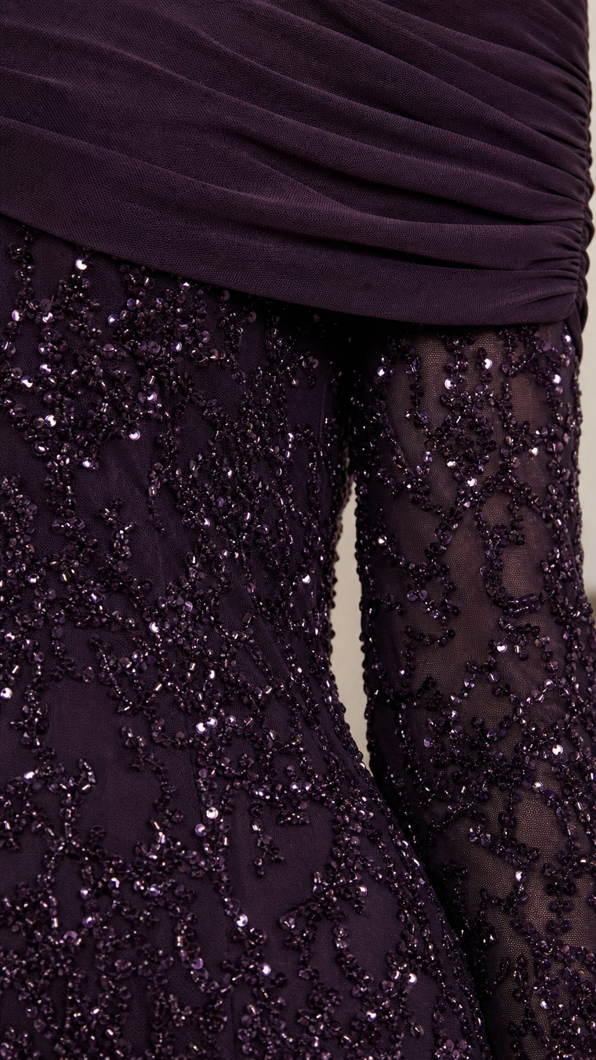 Close-up detail of the draped neckline and sequin embroidery