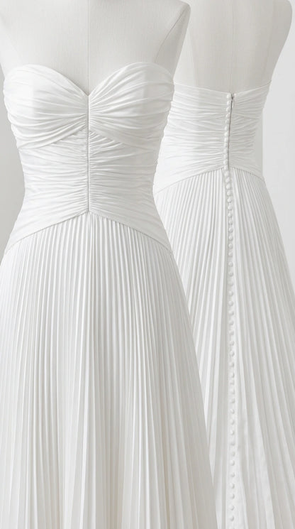Close-up detail of white ruched bodice and button back closure on mannequin