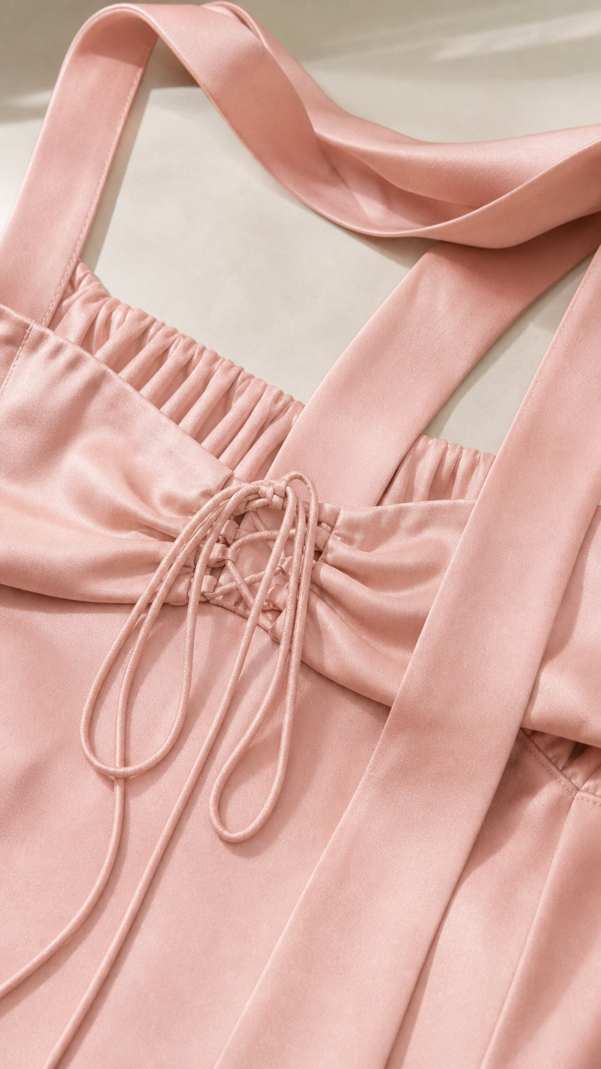 Close-up detail of Blush Pink satin dress showing back lace-up closure and ribbon straps