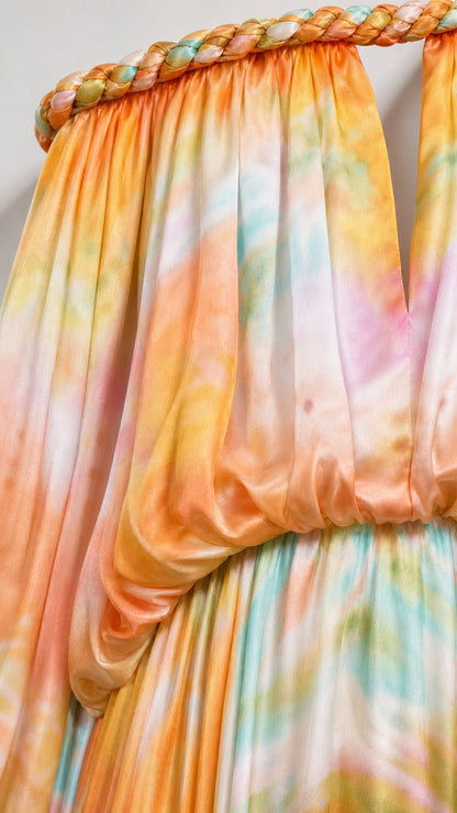 Close-up detail of braided neckline and smooth fabric on orange tie-dye dress