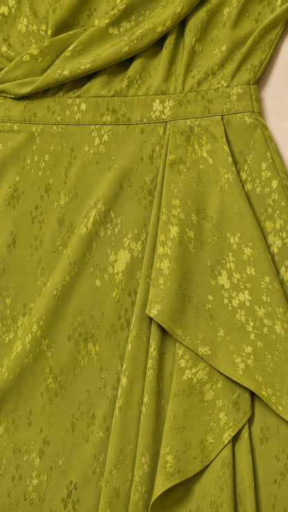 Close-up of fabric and ruffle detail on green dress