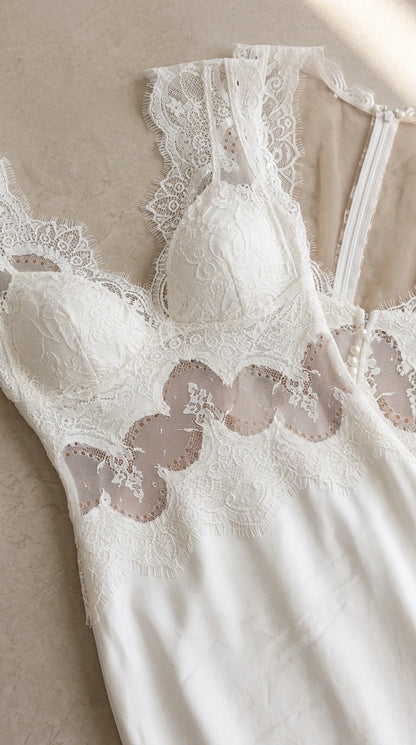 Close-up detail of white lace bodice with padded cups and eyelash trim