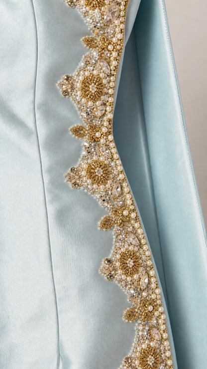 Close-up of gold and pearl embroidery detail on Light Blue fabric