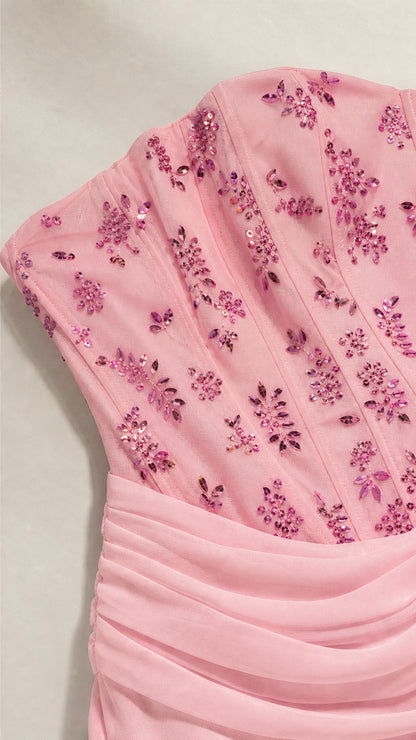 Close-up of pink beaded corset bodice with floral sequin embroidery and draped waistband