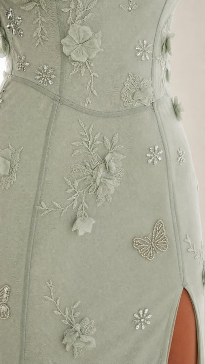 Close-up detail of 3D floral appliques and butterfly embroidery on Sage Green mesh dress
