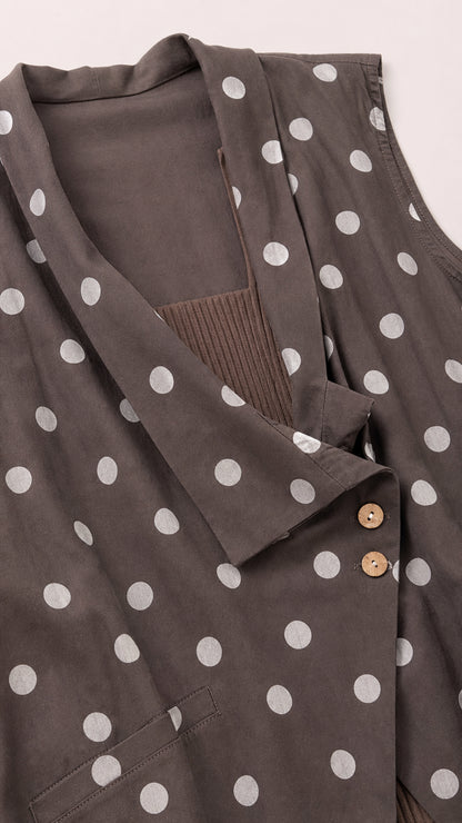 Close-up detail of brown polka dot vest lapel and buttons