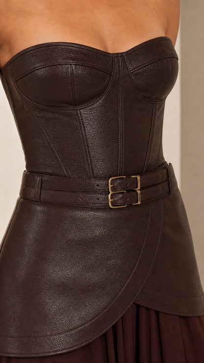 Close-up of textured faux leather bodice and buckled belt