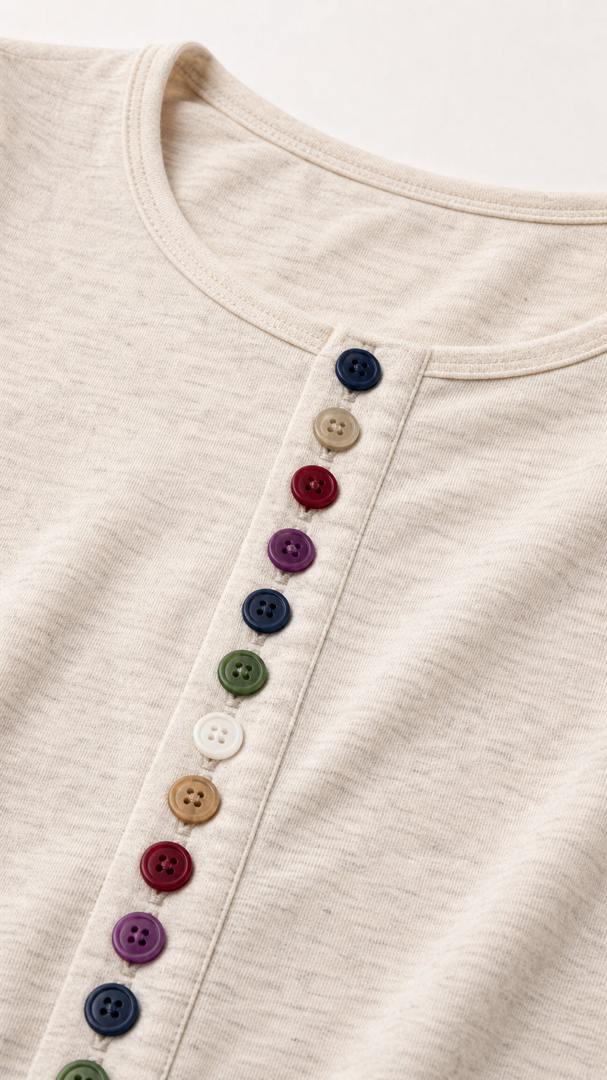 Close-up detail of the textured knit fabric and colorful rainbow front buttons