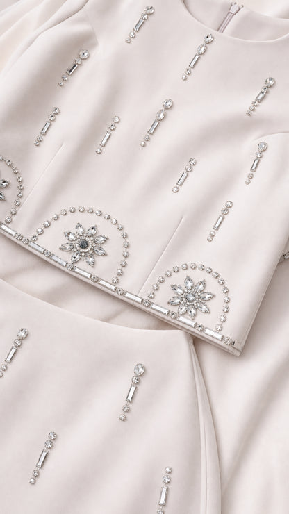 Close-up detail of sparkling crystal and rhinestone embellishments on the fabric