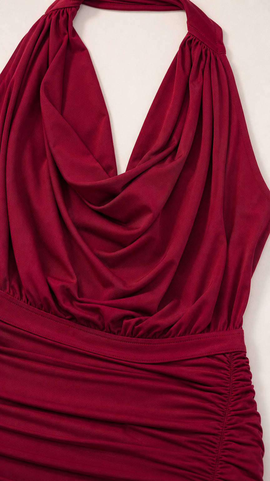 Close-up detail of burgundy draped cowl neckline and gathered ruched fabric