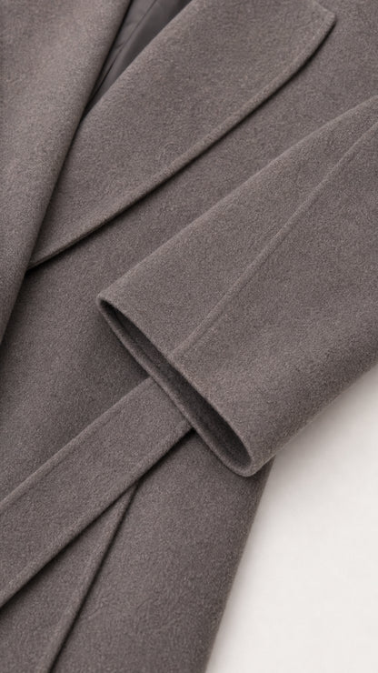Close-up detail of grey brushed fabric cuff and belt