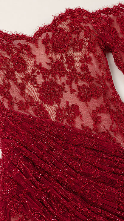 Close-up of lace pattern and texture on red evening gown