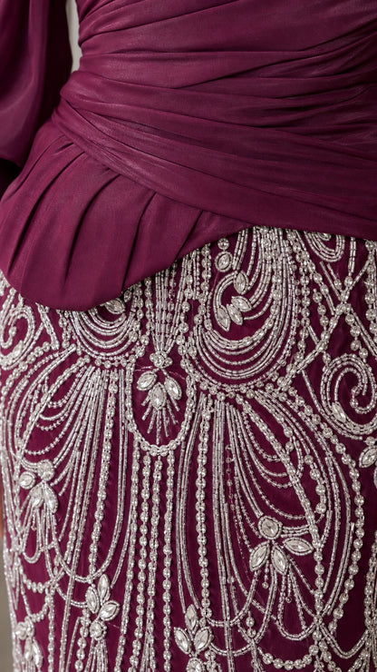 Close-up of beaded crystal pattern and ruched bodice on burgundy dress