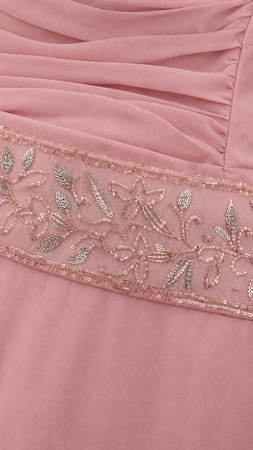 Close-up detail of delicate floral beadwork and pleating on dusty rose dress waist