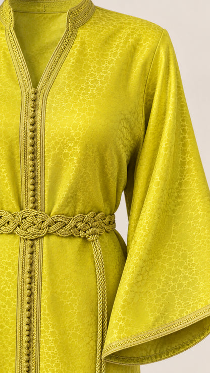 Close-up detail of Lime Green kaftan showing textured jacquard fabric, braided trim, and tassel belt