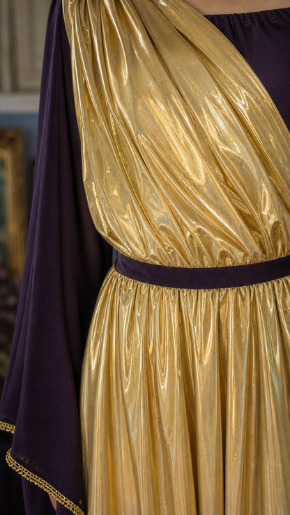 Close-up of gold metallic pleated fabric and draped sash detail