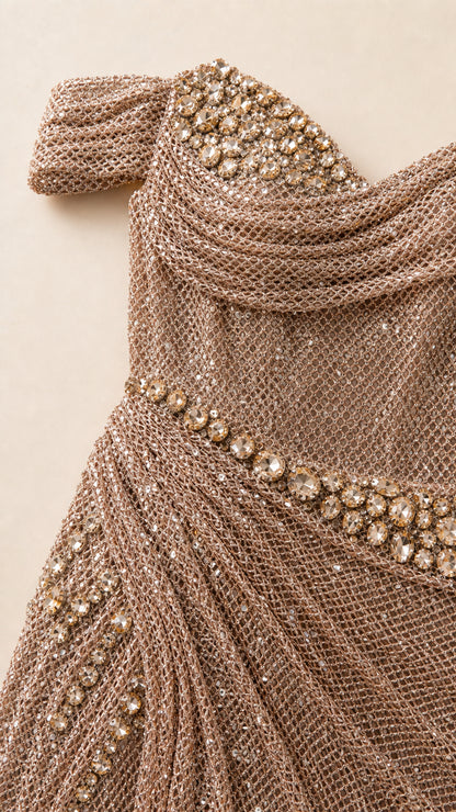 Close-up detail of crystal embellishments and metallic mesh texture on bodice