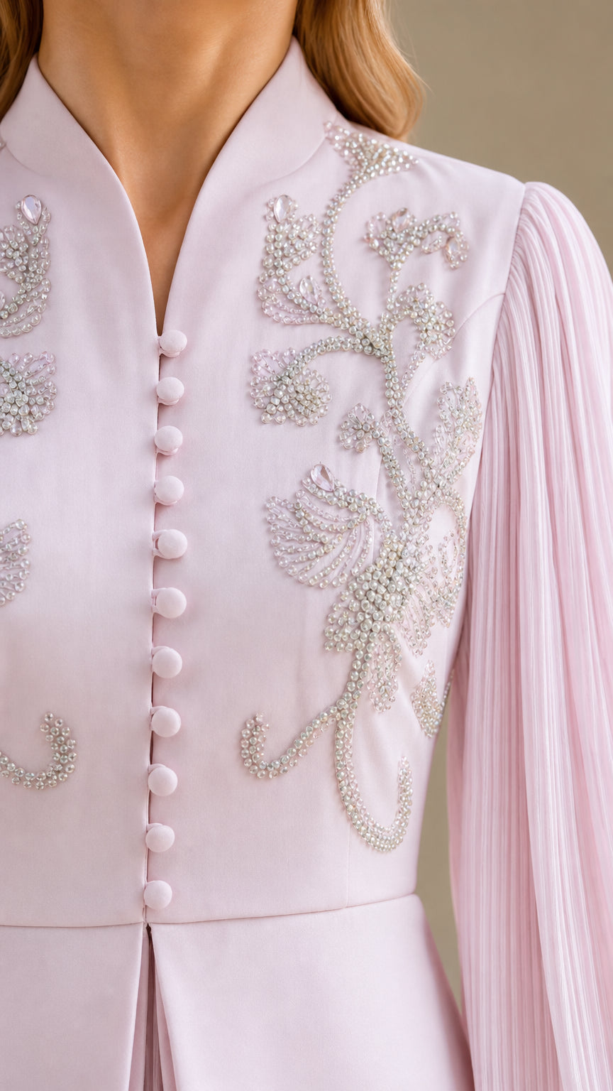 Close-up of bodice embroidery and beadwork on light pink dress