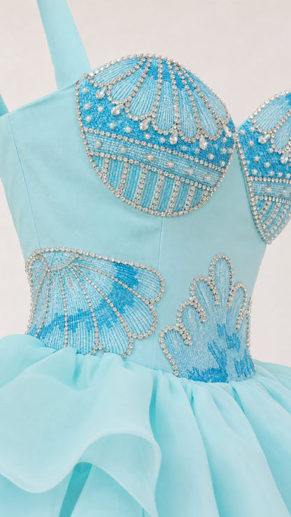 Close-up detail of beaded seashell bodice and organza peplum