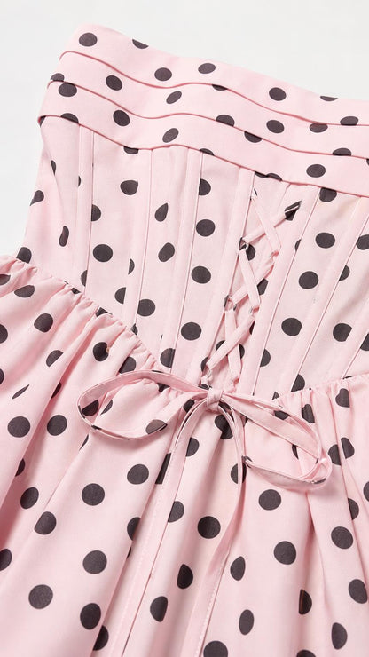 Close-up of the lace-up back and pleated bodice on pink polka dot dress
