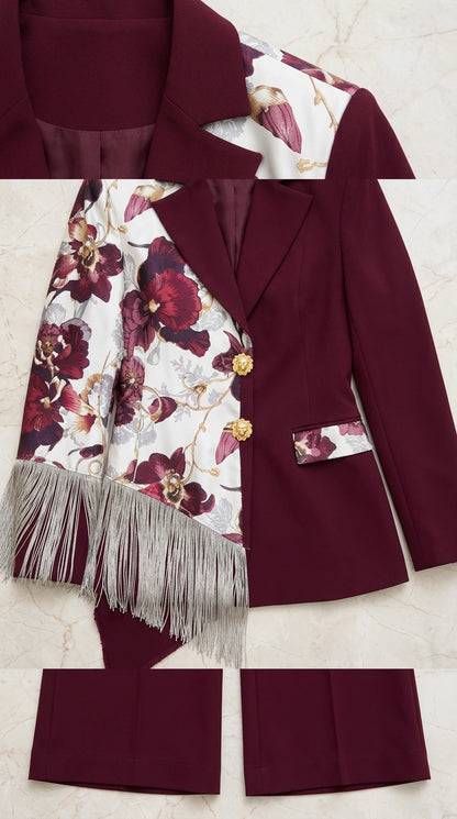 Close-up detail of burgundy suit lapel, floral pattern, gold button, and fringe trim