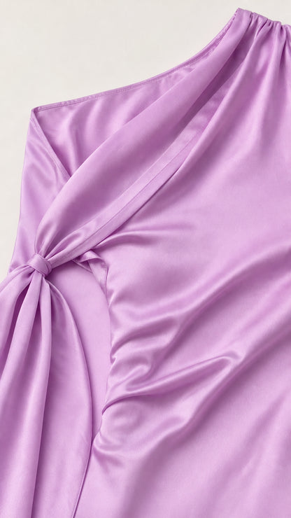 Close-up of knotted shoulder drape detail on lavender satin dress