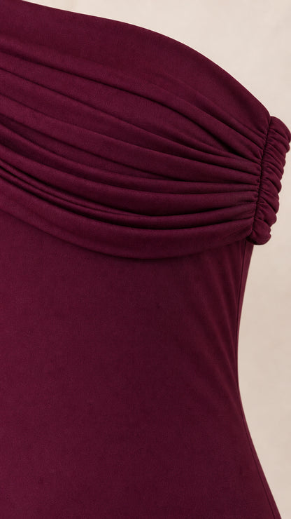 Close-up detail of gathered ruched one-shoulder neckline in burgundy