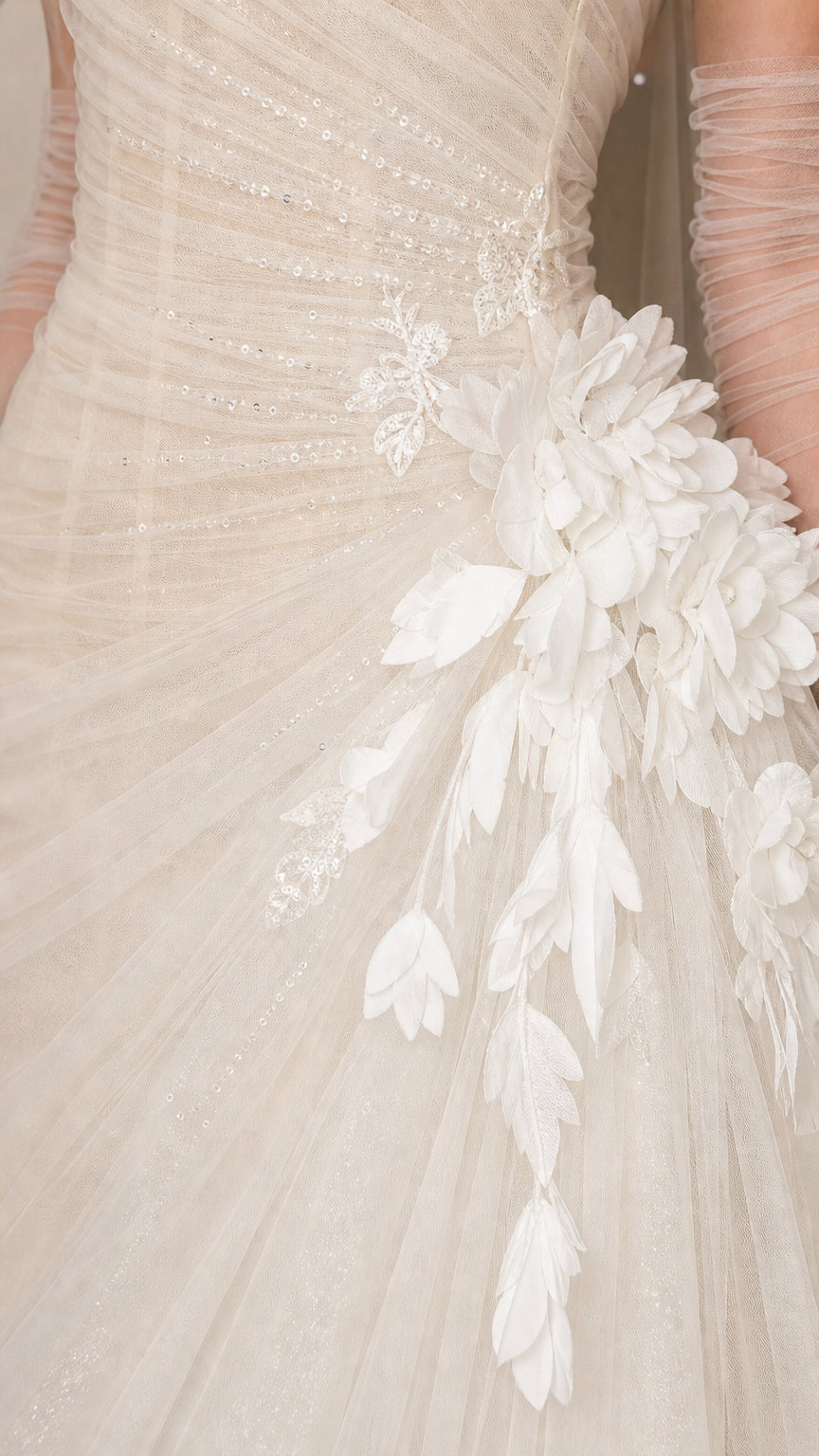 Close-up detail of white tulle fabric and 3D floral appliques