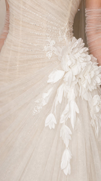 Close-up detail of white tulle fabric and 3D floral appliques