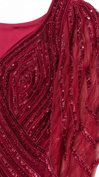 Close-up detail of burgundy sequin and bead chevron embroidery on mesh