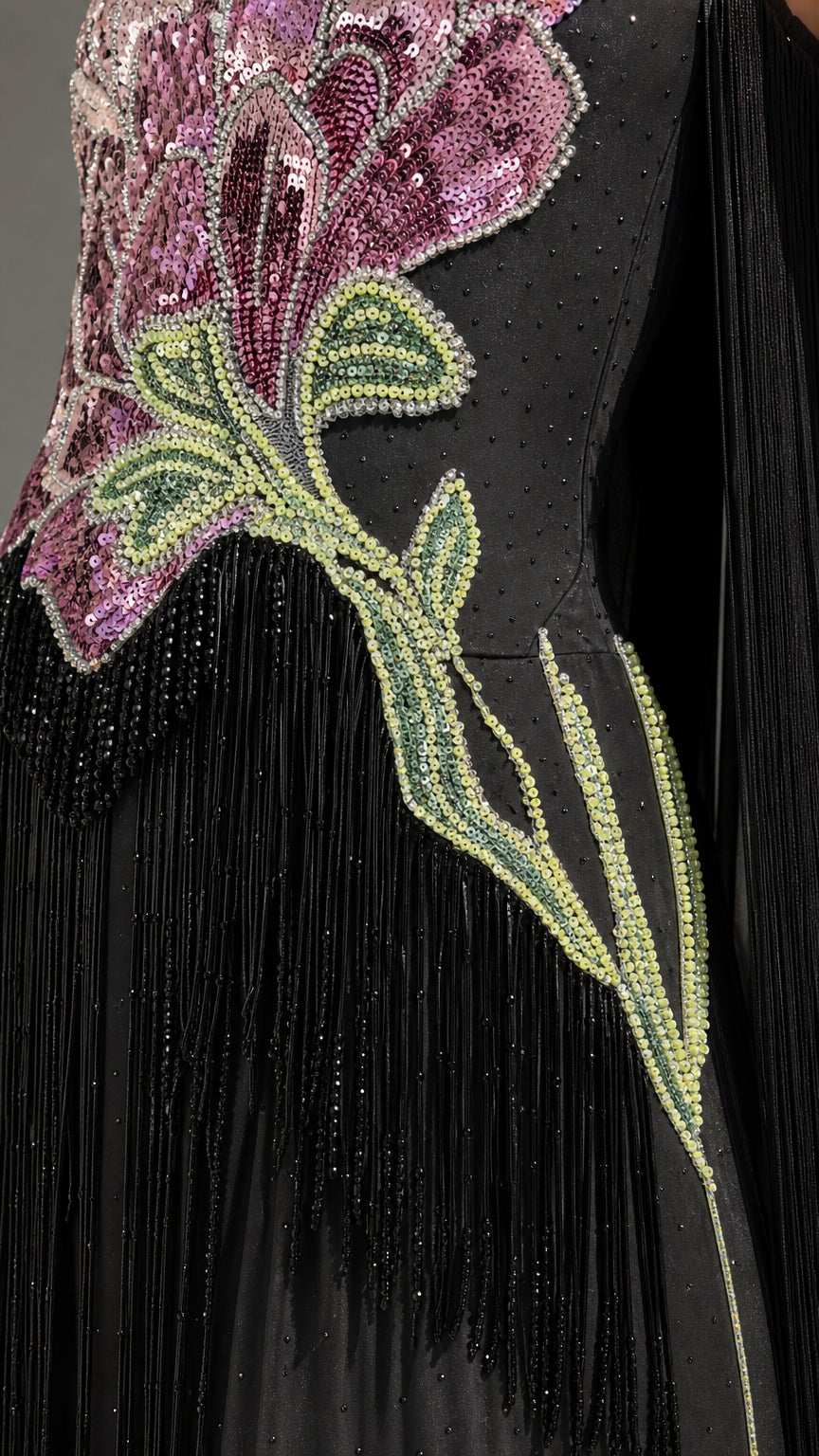 Close-up detail of sequin floral embroidery and fringe on black gown
