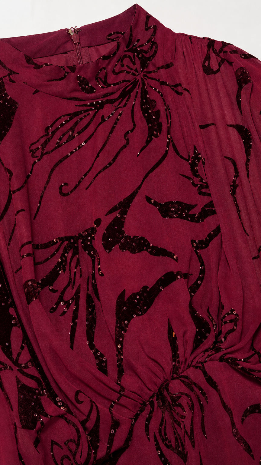 Close-up of mock neck and sequin floral pattern