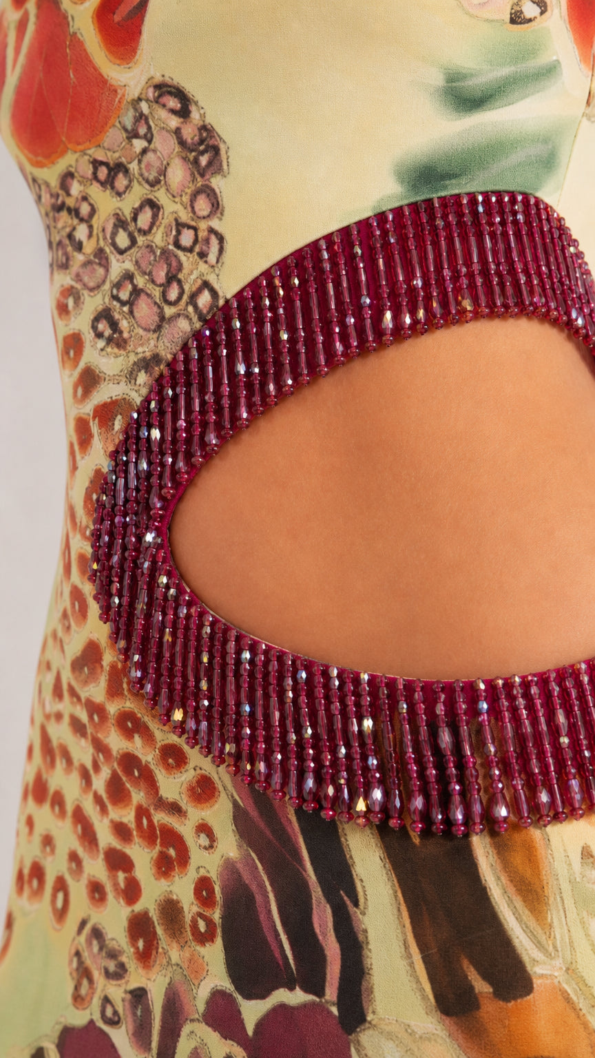 Close-up of beaded fringe trim along the waist cutout
