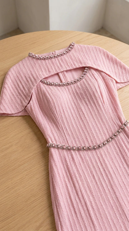 Close up of beaded trim and cutout on pink pleated evening dress