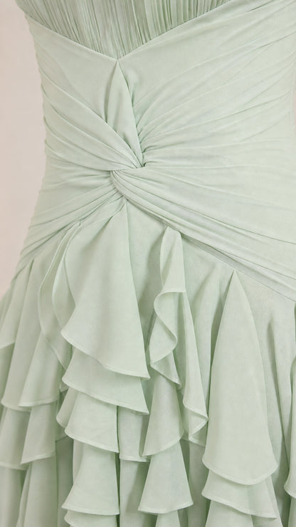 Close-up detail of twisted bodice and ruffle texture on sage green dress