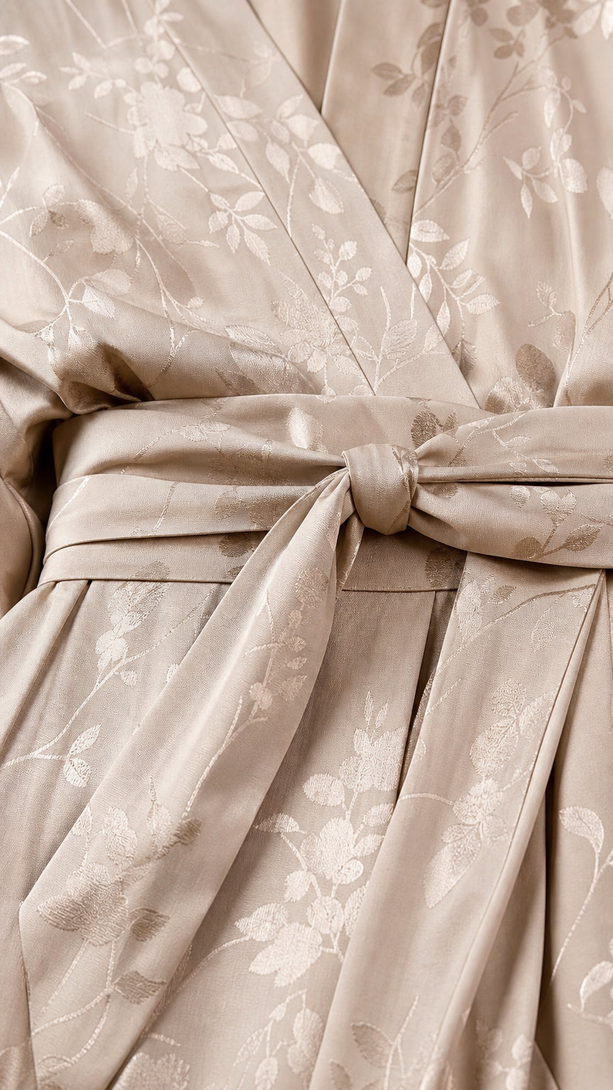 Close-up of fabric texture and self-tie belt on champagne jumpsuit