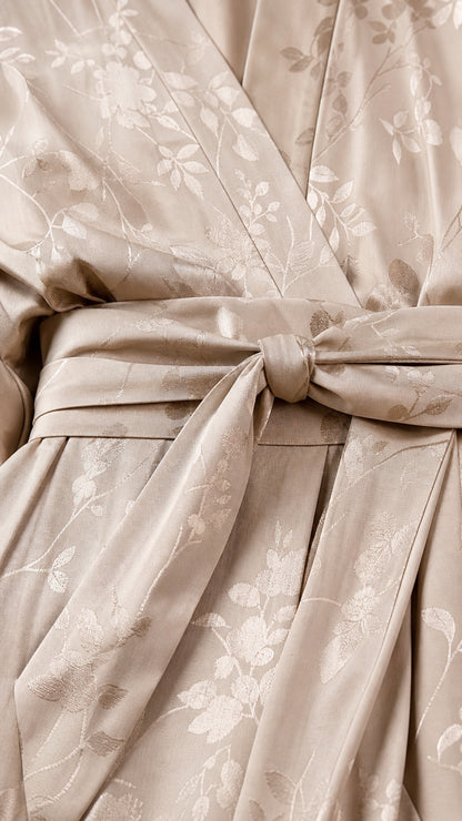 Close-up of fabric texture and self-tie belt on champagne jumpsuit