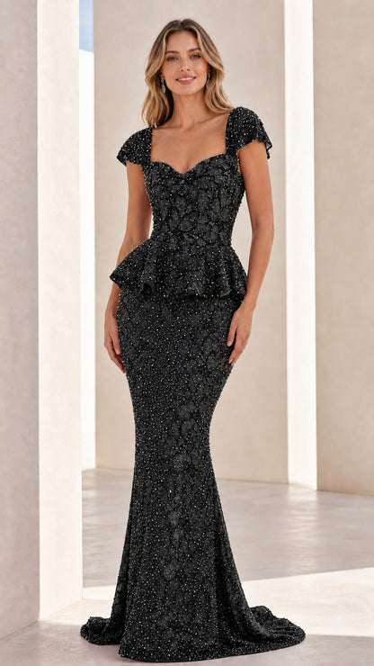 Front view of black embellished evening gown