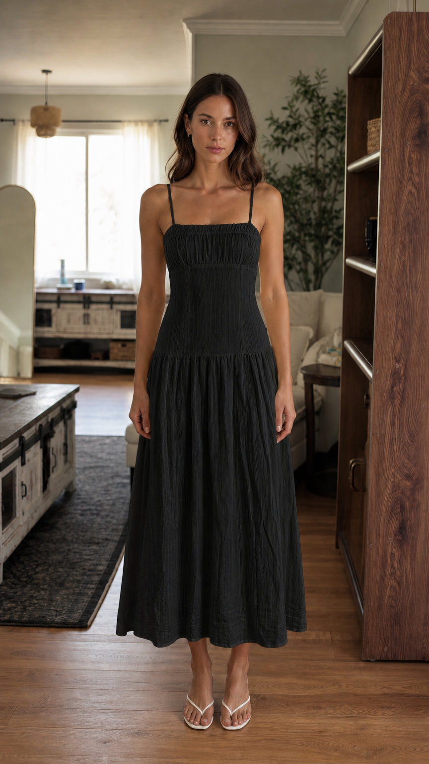 Woman wearing black smocked midi dress