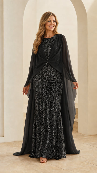 Model wearing black sequin lace formal evening gown with matching chiffon capelet