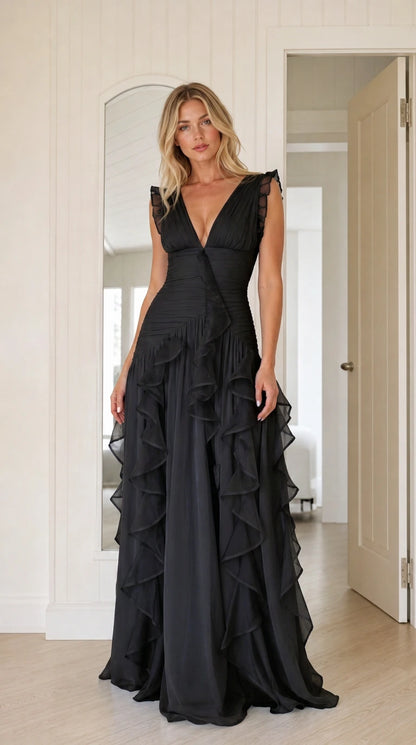 Woman wearing black plunging v-neck cascading ruffle evening maxi dress