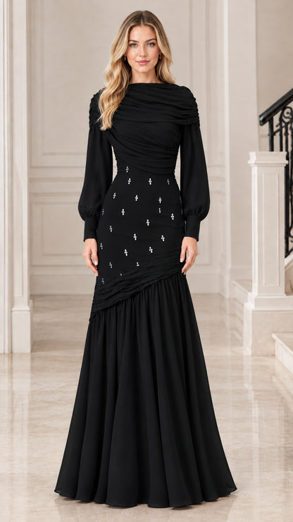 Model wearing classic Black long sleeve draped evening gown with rhinestone accents