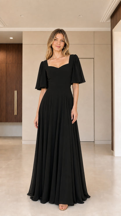 Woman wearing classic black sweetheart flutter sleeve maxi gown