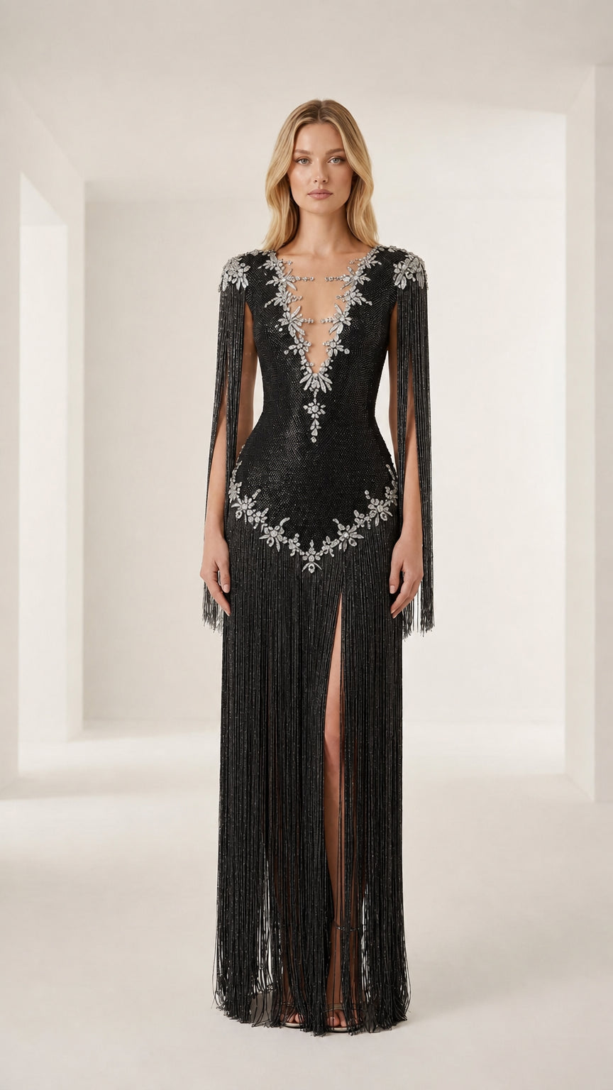 Front view of model wearing a black crystal-embellished fringe evening gown