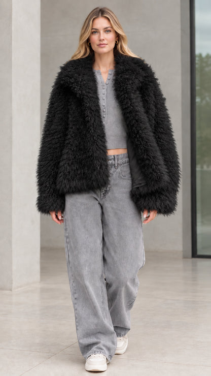 Front view of model wearing black shaggy faux fur jacket
