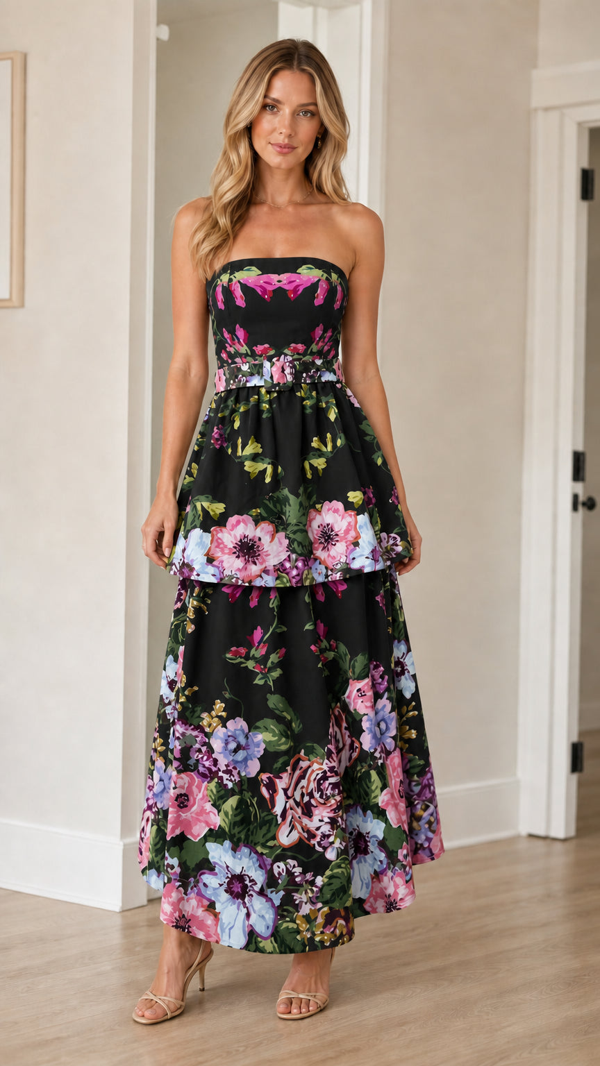 Woman wearing black floral strapless tiered maxi dress