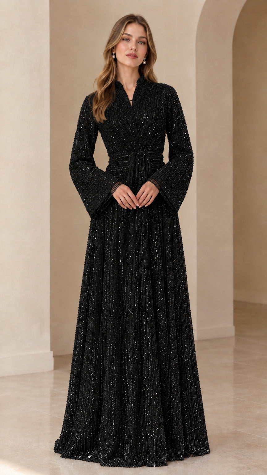 Front view of model wearing black sequined long sleeve maxi evening gown