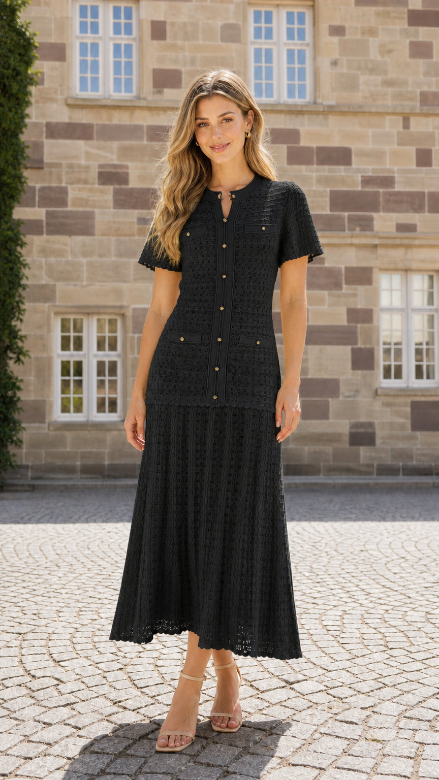Front view of model wearing black textured knit midi dress