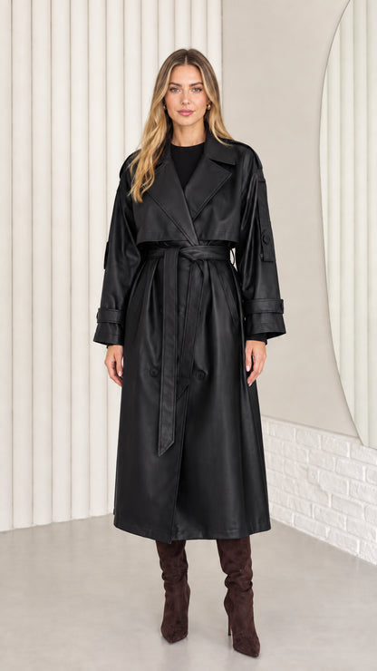 Full-length front view of woman wearing black faux leather belted trench coat